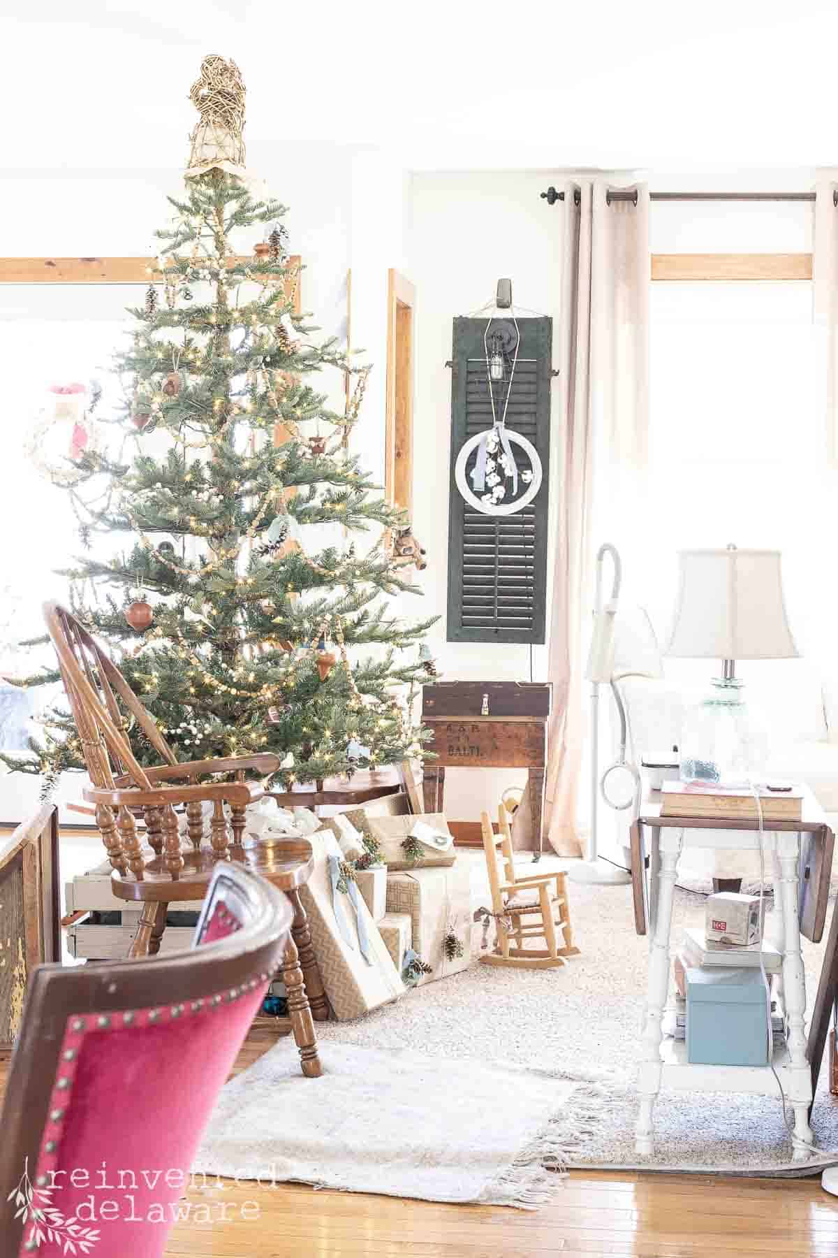 Christmas tree in an open concept living space with wrapped packages underneatht the tree