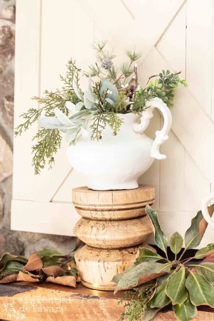 ironstone pitcher filled with faux greenery used for fireplace mantle decor