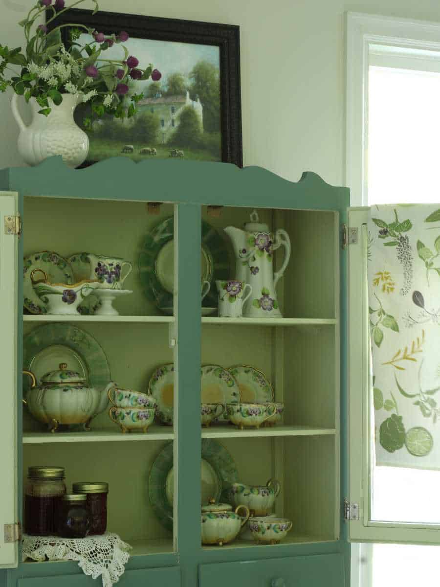 vintage cabinet styled with vintage dishes