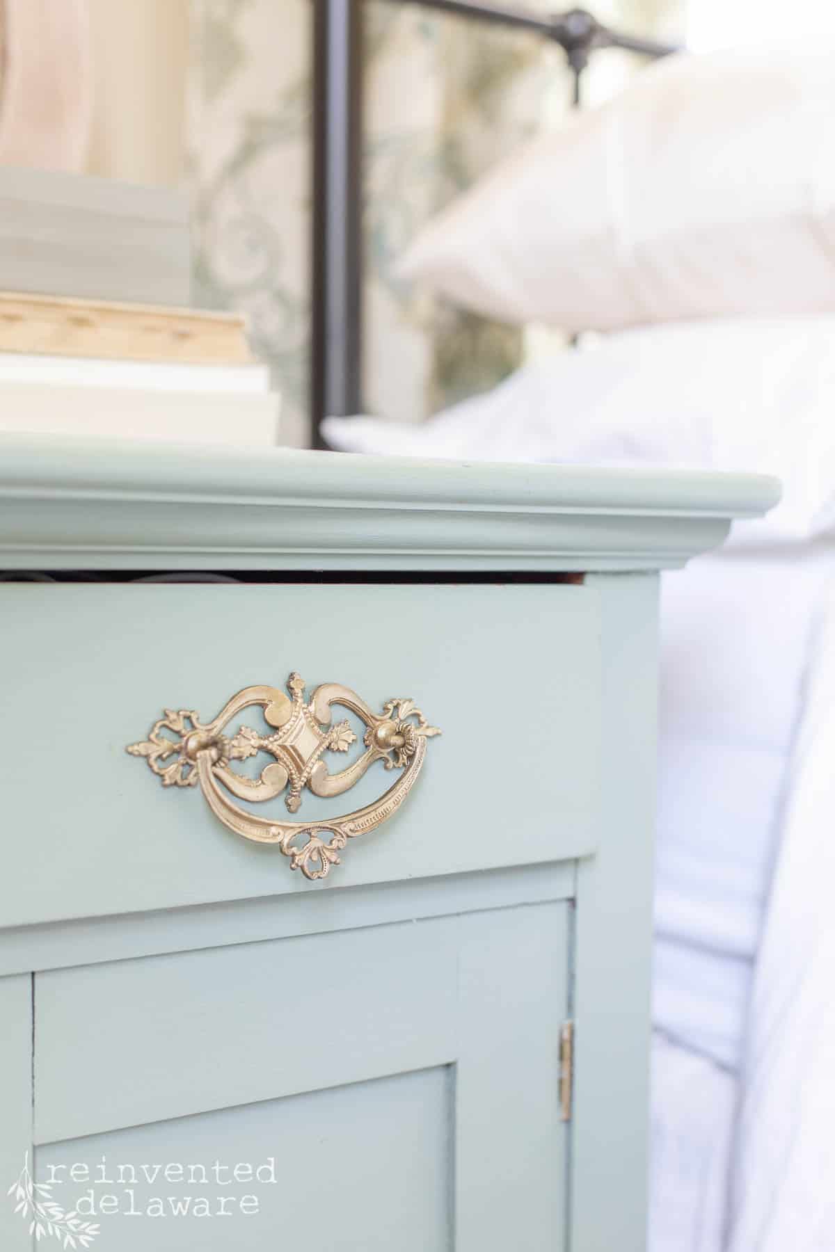 close up of restored brass hardware on antique furniture makeover