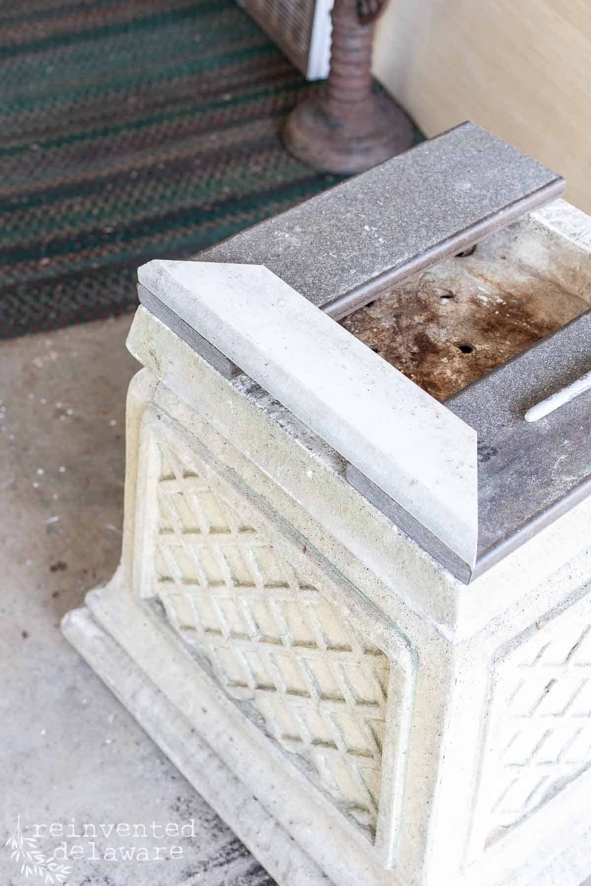 boards cut in a miter to fit an upcycled planter for a patio