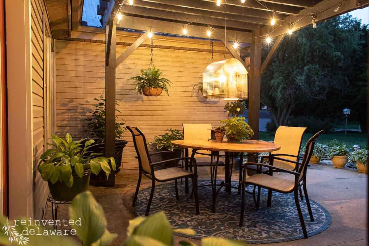 night scene of a backyard patio with upcycled planters