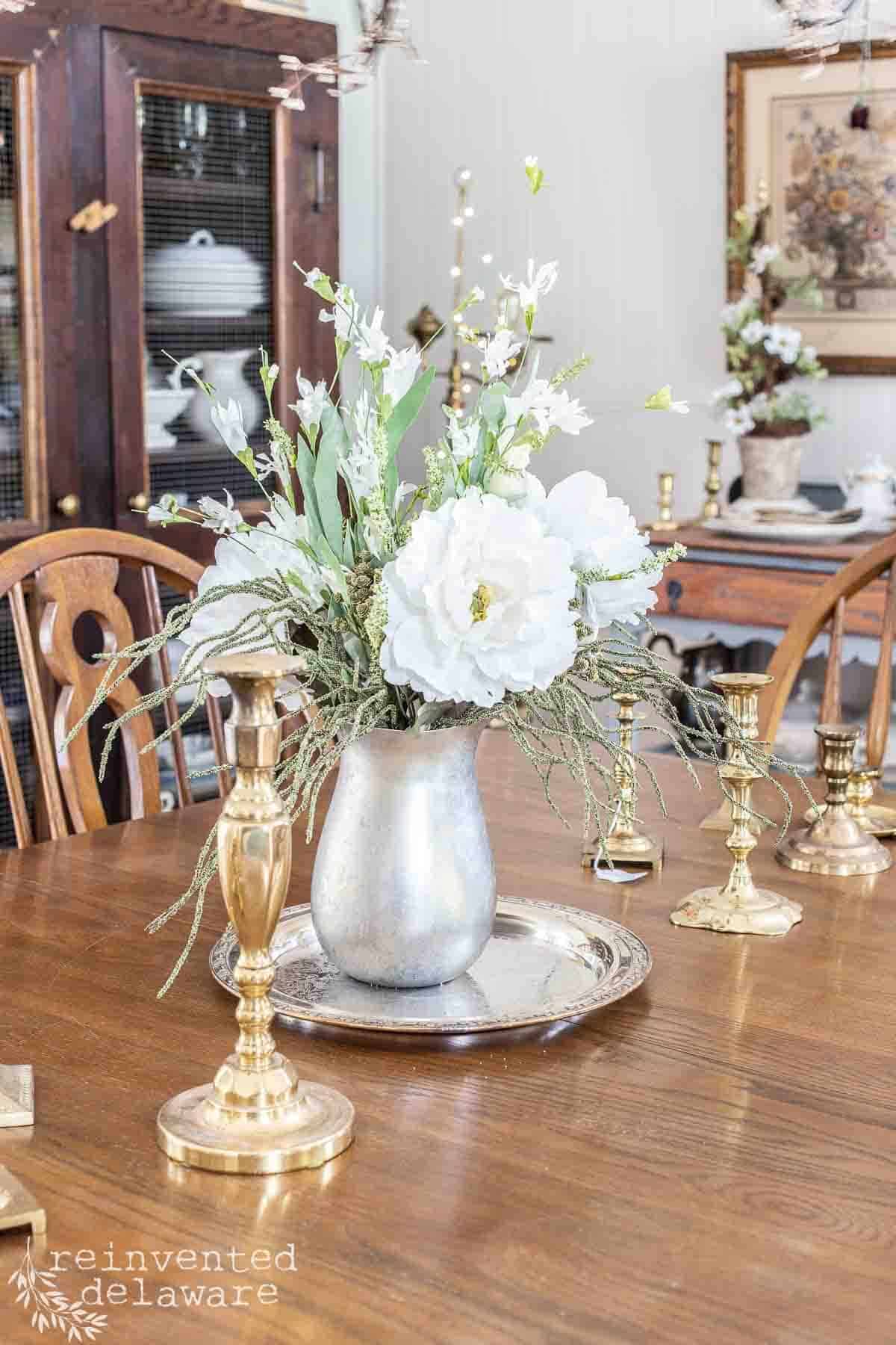 upcycled silver pitcher turned into vintage inspried home decor in a dining room