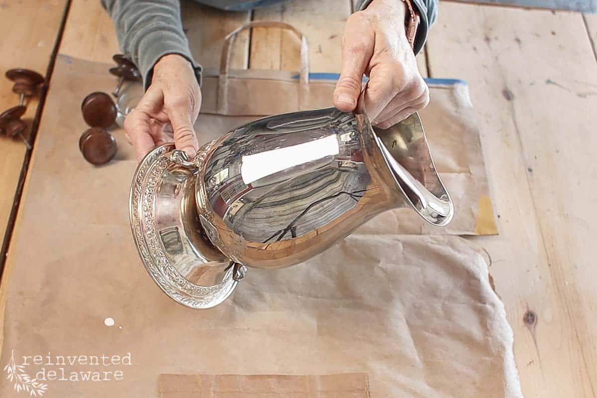 lady testing ways to make a pitcher stand upright without feet