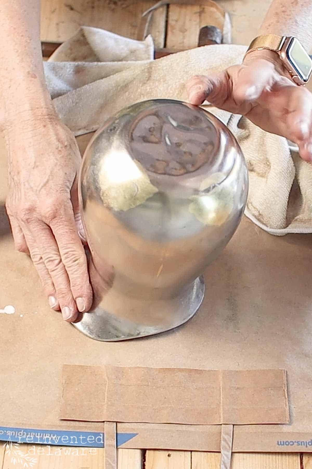 hammered bottom of vintage silver pitcher repurposed into flower vase