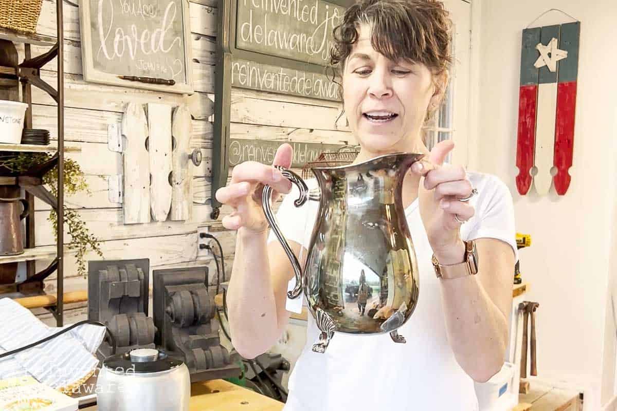 lady holding an old vintage silver pitcher for a DIY home decor makeover project