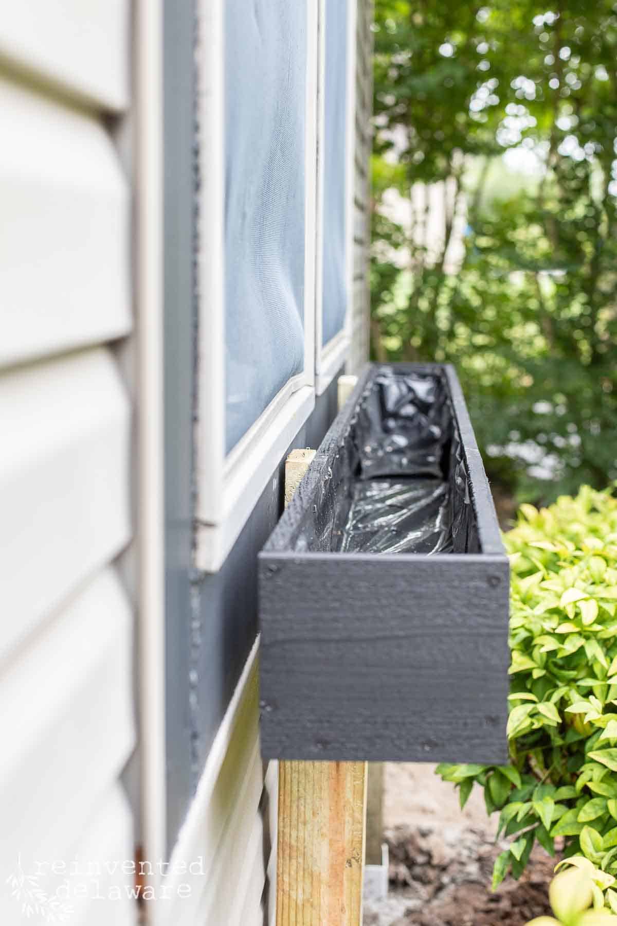 easy diy window box planter on a homes exterior