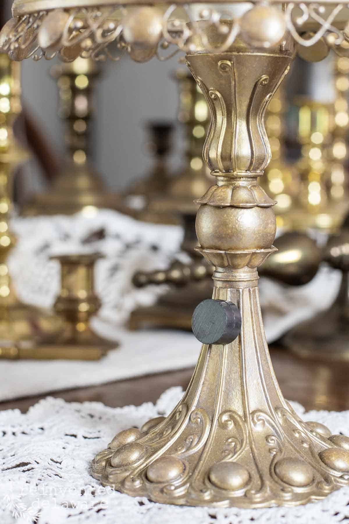 close view on magnet test for brass identification on a small lamp