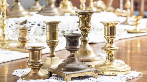 five small vintage brass candlesticks grouped together
