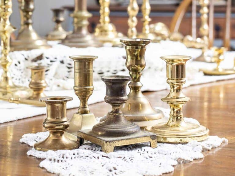 five small vintage brass candlesticks grouped together