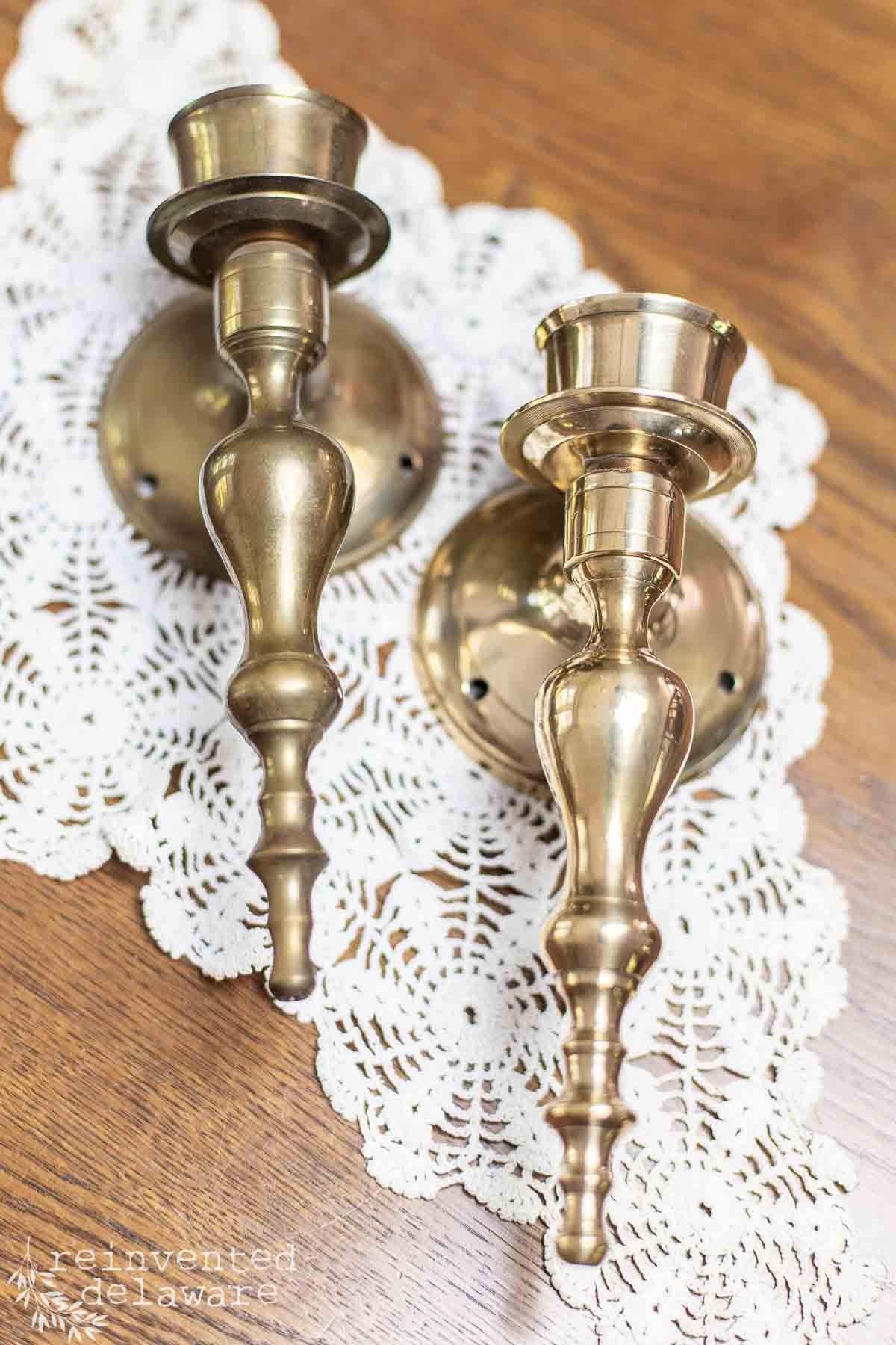 pair of real brass wall sconces with one polished and one tarnished