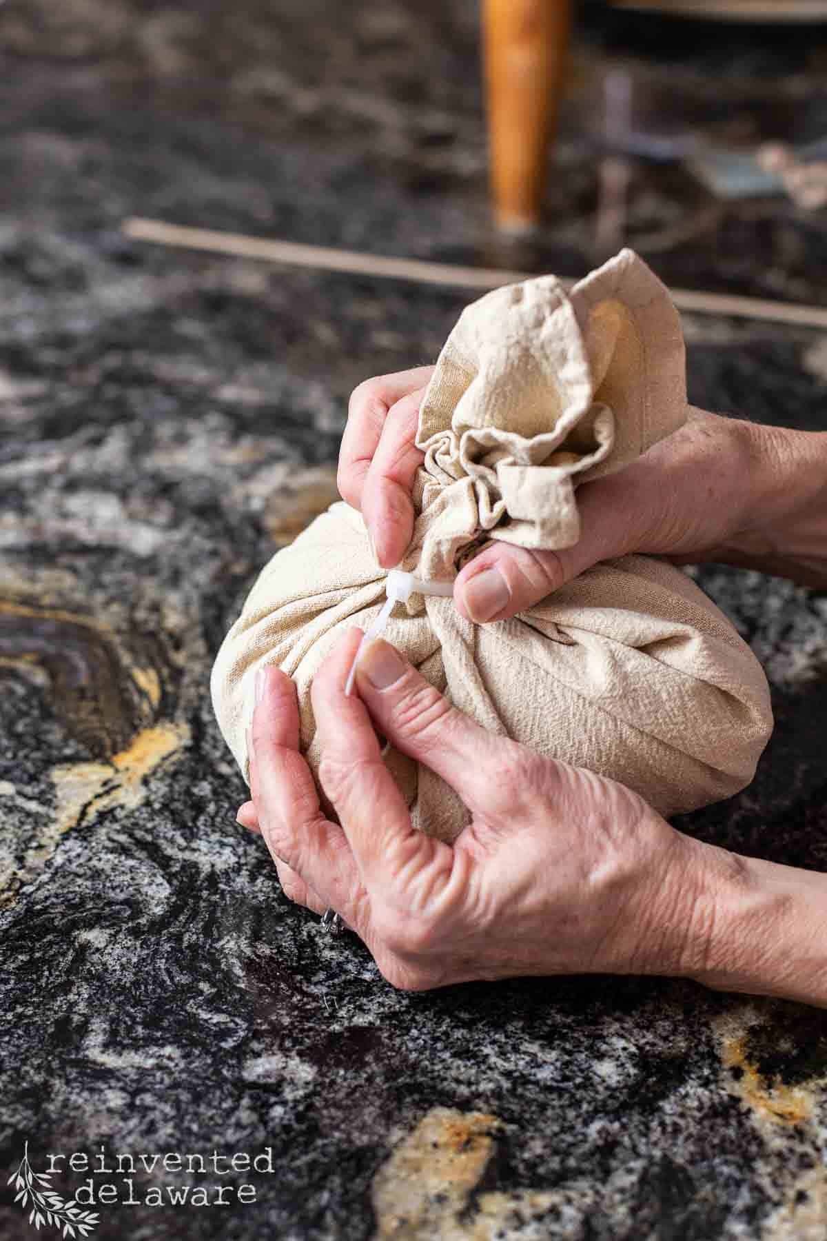 lady making a small craft pumpkin using a cloth napkin