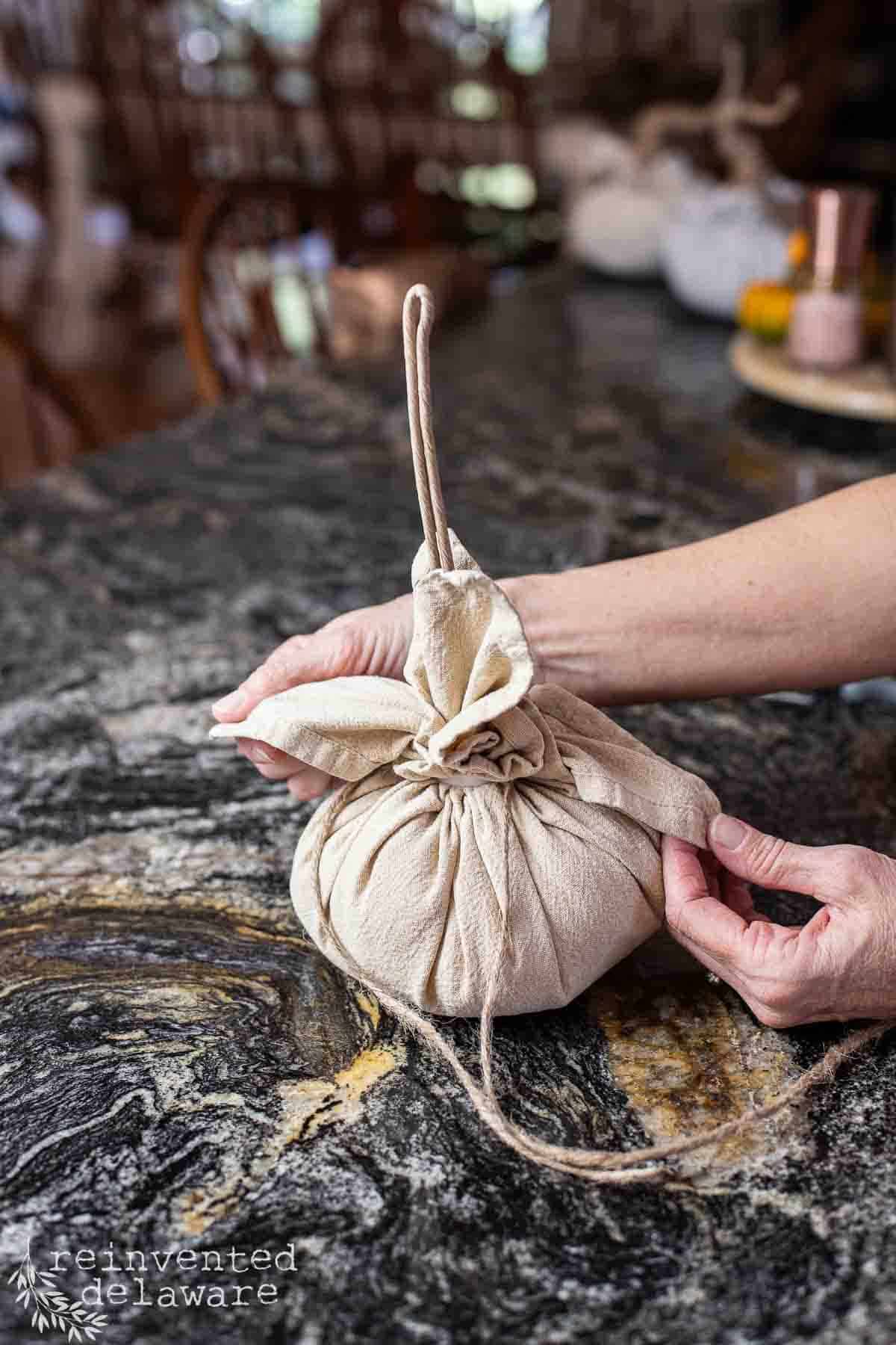 lady showing to to make a cloth napkin pumpkin craft