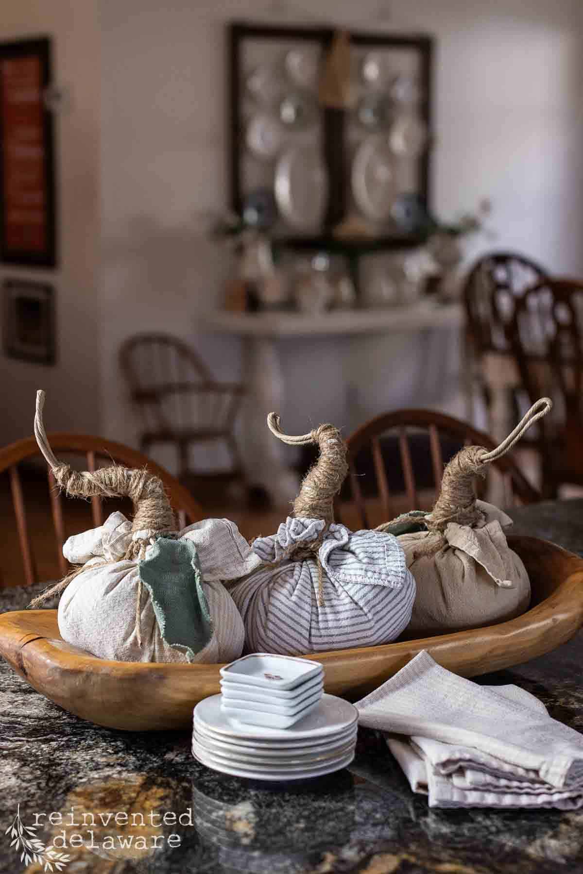 three cloth pumpkins in a dough bowl for fall decor