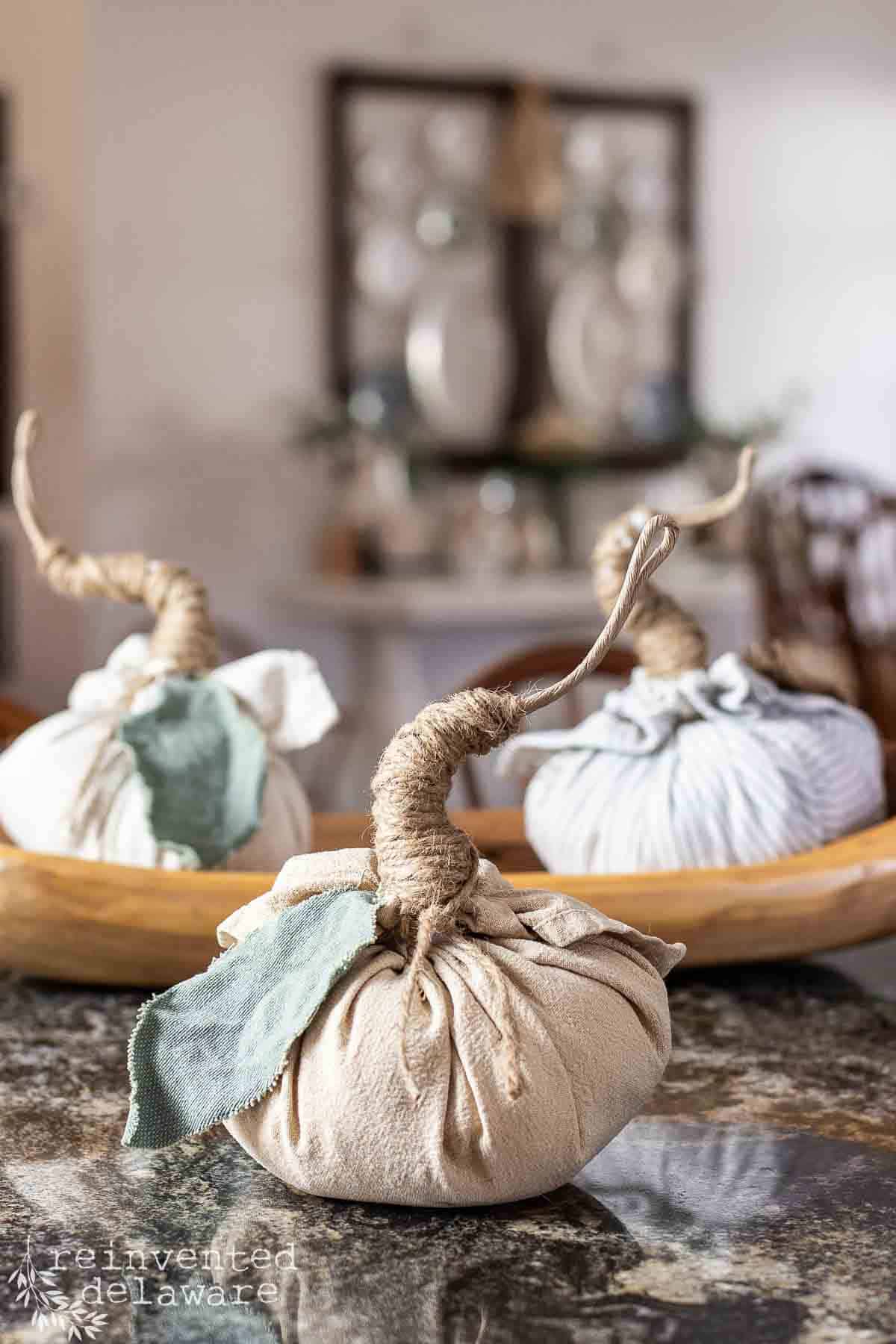 tan cloth napkin made into a craft pumpkin