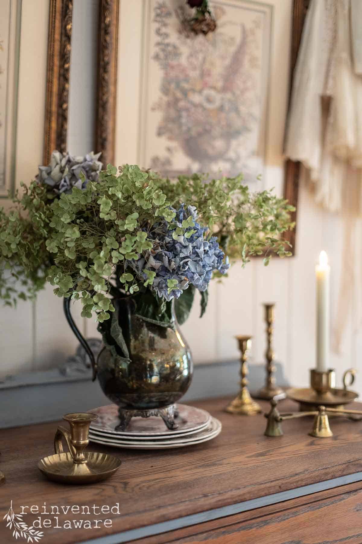 vintage silver pitcher filled with dried hydrangeas