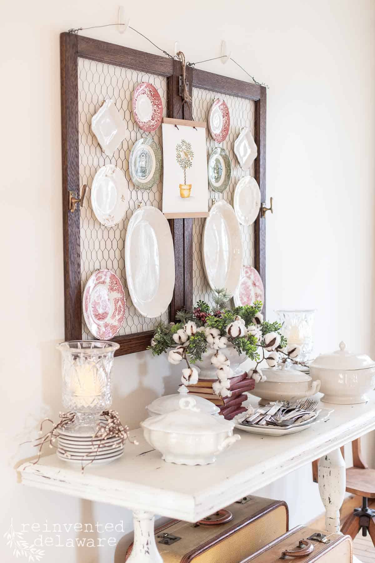 vintage ironstone plates hanging on wall for the holiday season