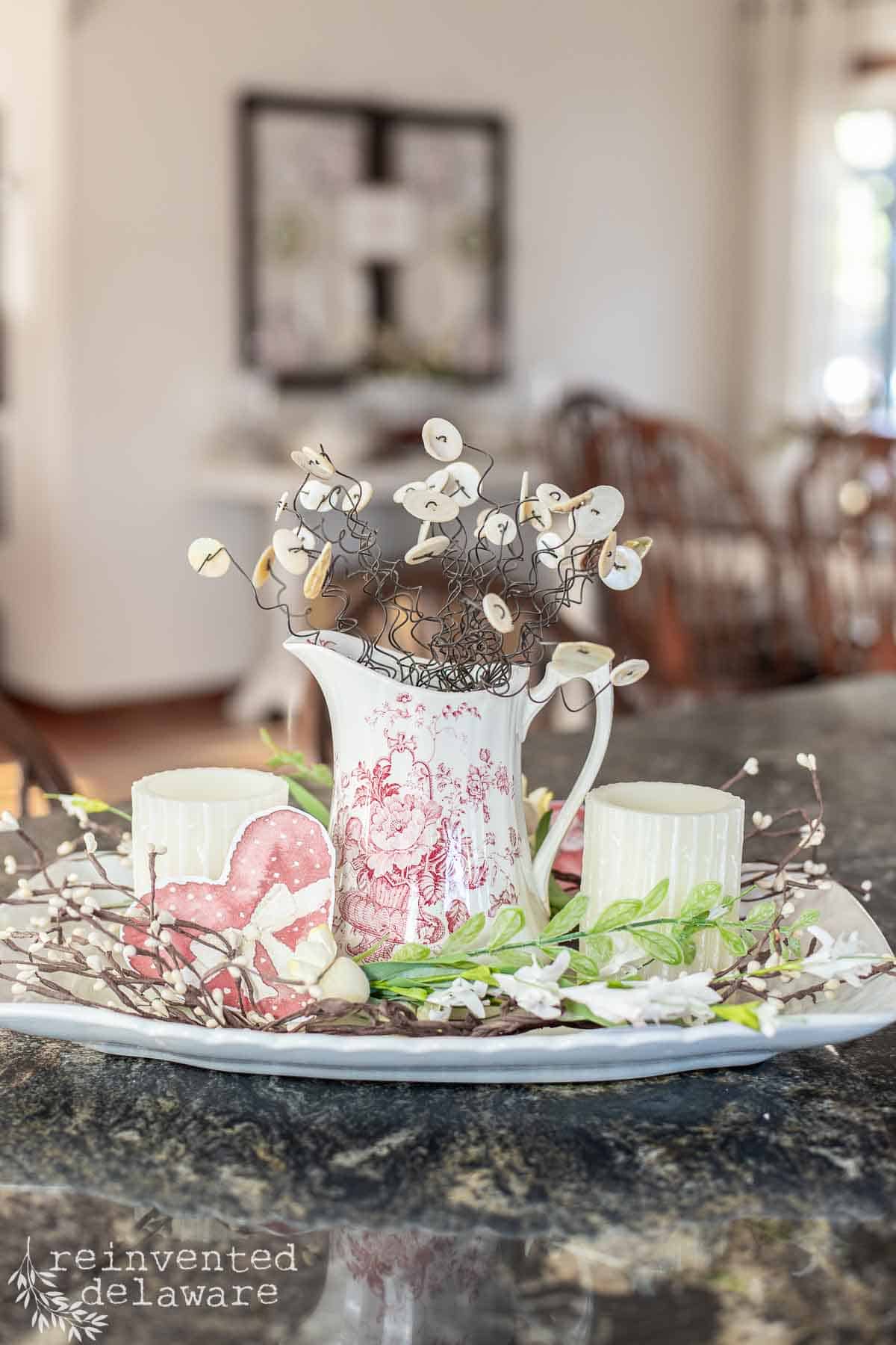 vintage red transferware pitcher with button flowers