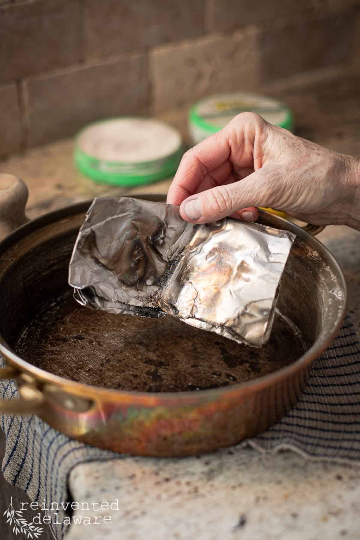 aluminum foil used to clean the lining of a tin lined copper pan