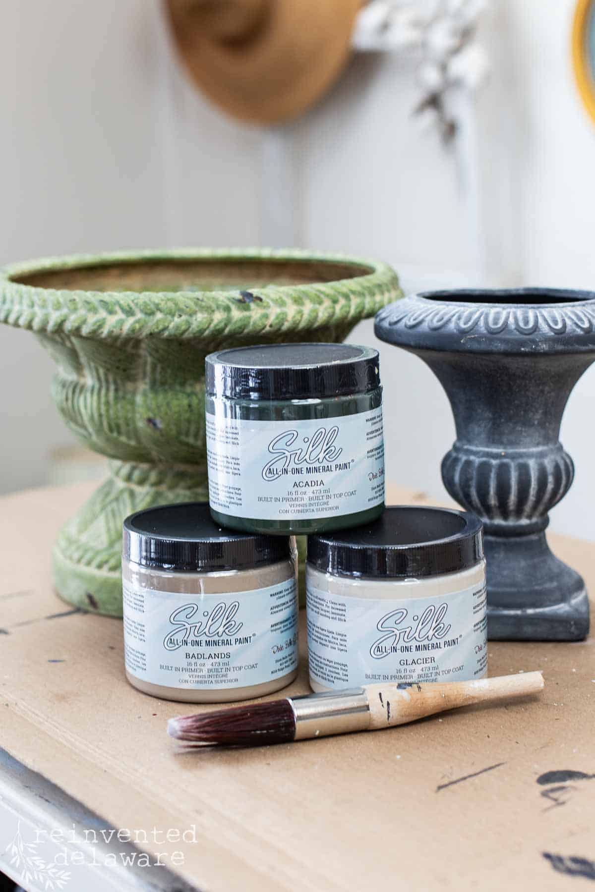 before images of thrift store planters ready for a makeover using paint to create a concrete look