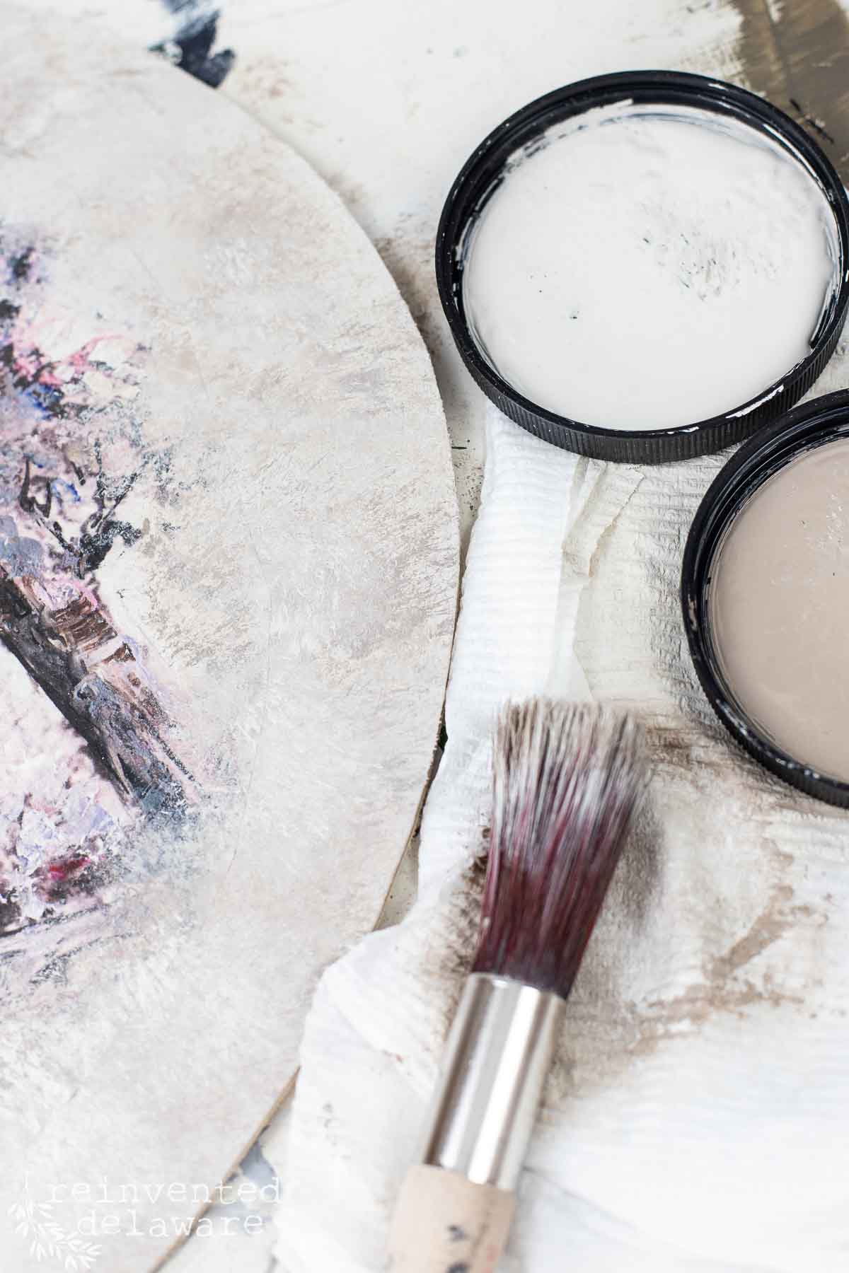 painting technique to cover the hard edge of decoupage paper on a thrift store artwork piece for upcycled home decor