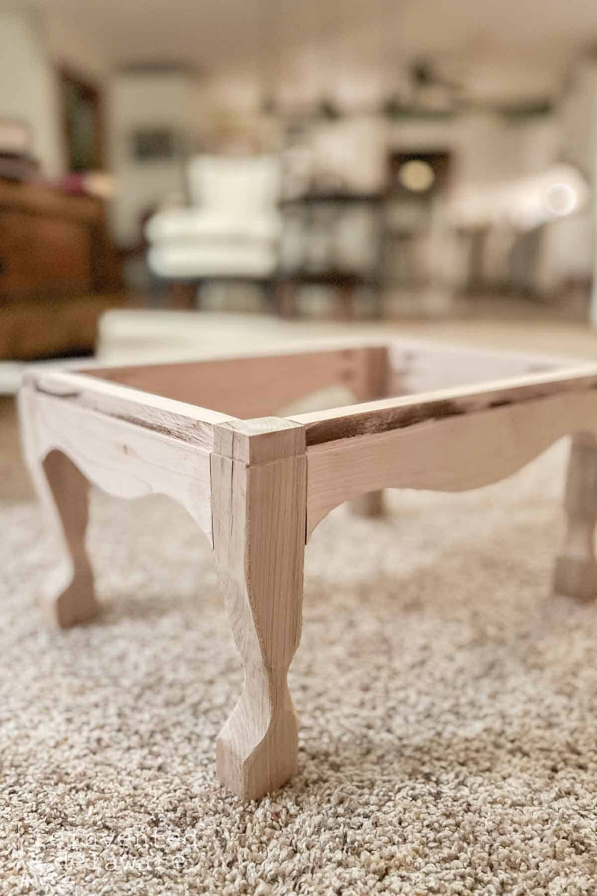 small stool without upholstery before the reupholsery is finish