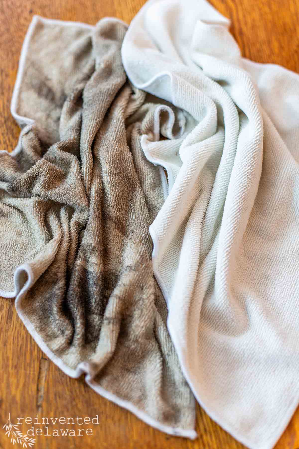 two cloths used to clean old furniture, one cloth is very dirty and one cloth is clean.