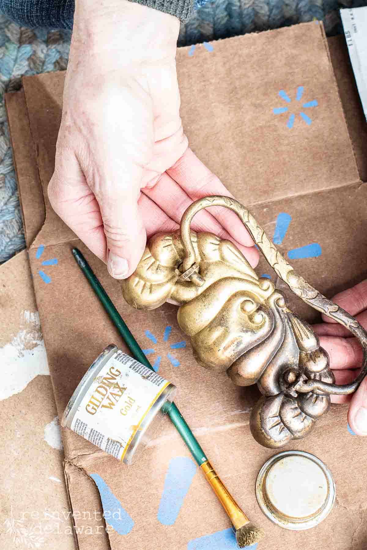 old brass furniture drawers pulls that have been upcycled with gold gilding wax.