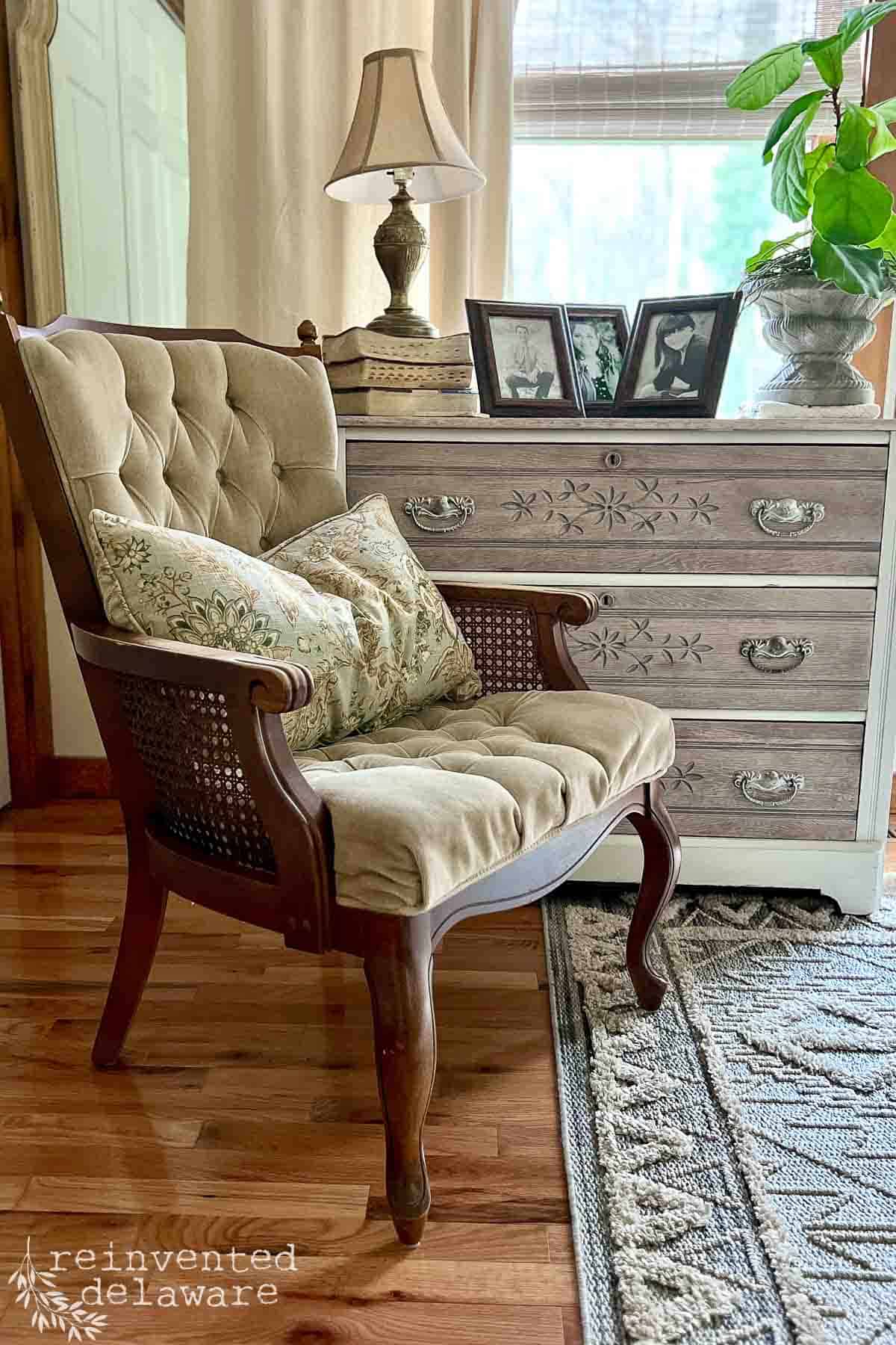 upholstered chair with tufting and caning on the sides