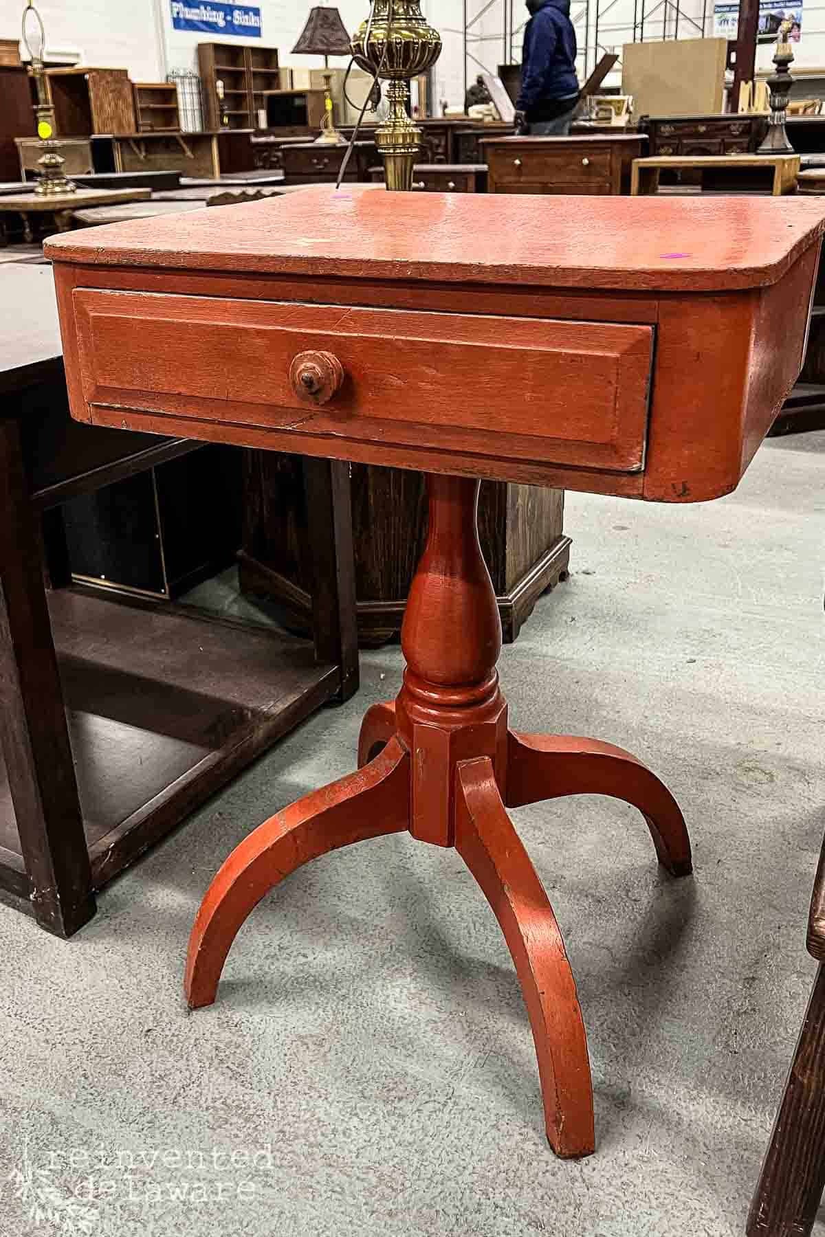 an old orange colored side table inside a Habitat for Humanity Restore location in Prices Corner in Delaware