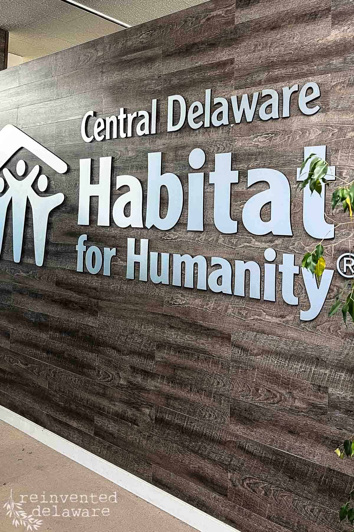 large sign inside of a Restore with text Central Delaware habitat for Humanity