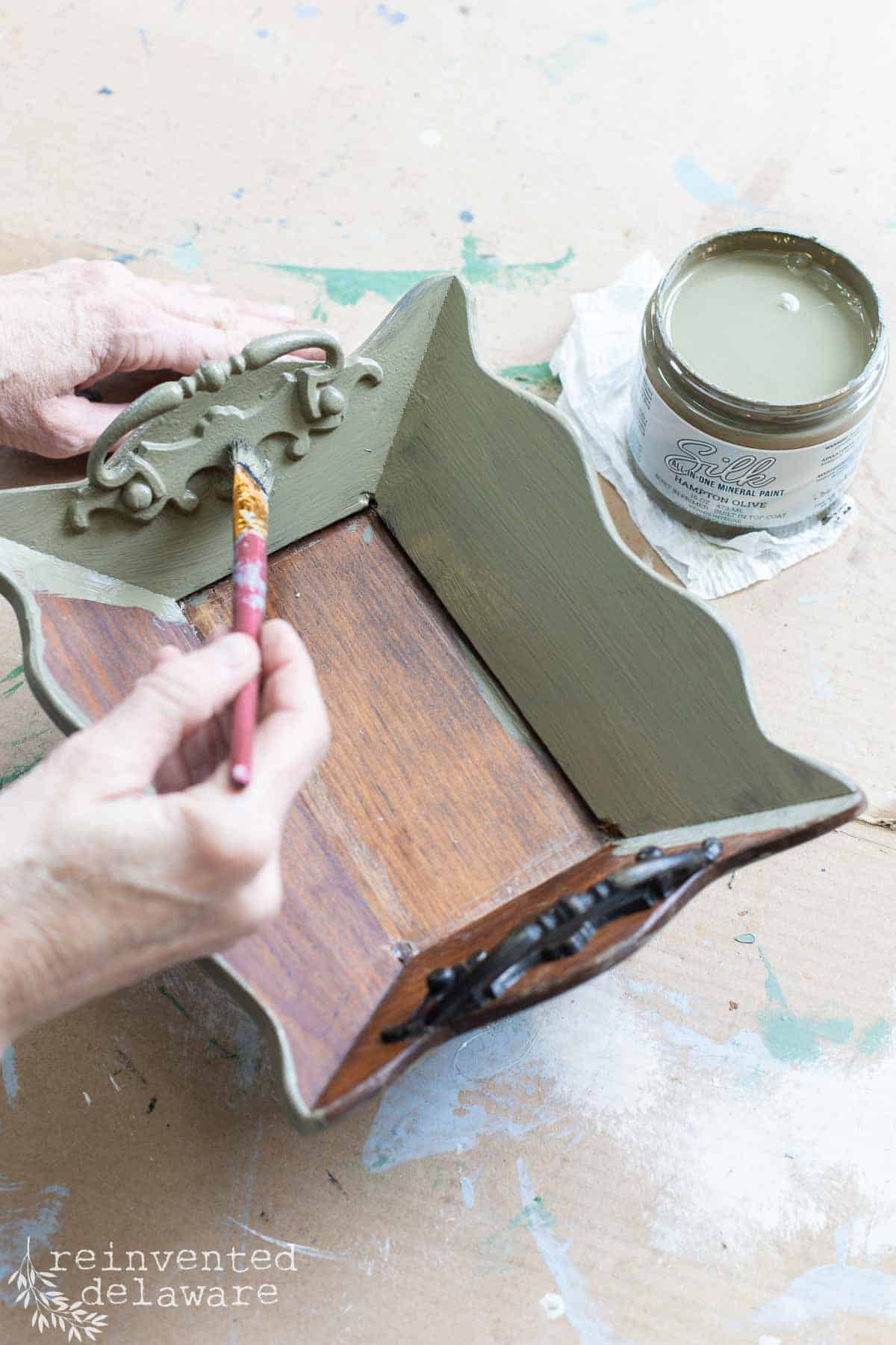 lady painting small wooden tray for an flea market flip upcycle project