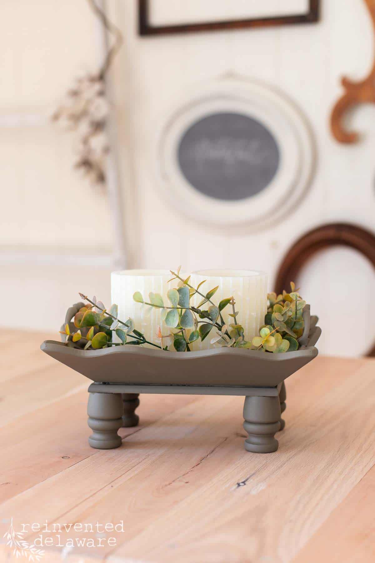 upcycled wooden tray with faux candles and greeenery the tray has been painted in olive green.