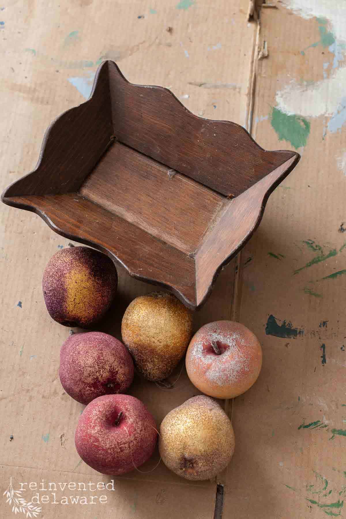 small wooden tray and faux fruit ready for a flea market flip upcycle.