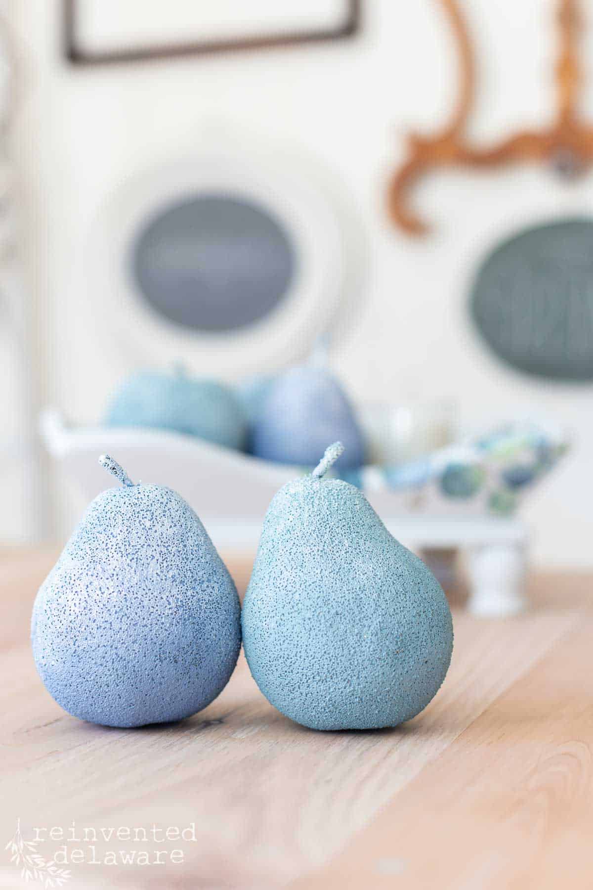 close up of painted faux fruit in blue and green