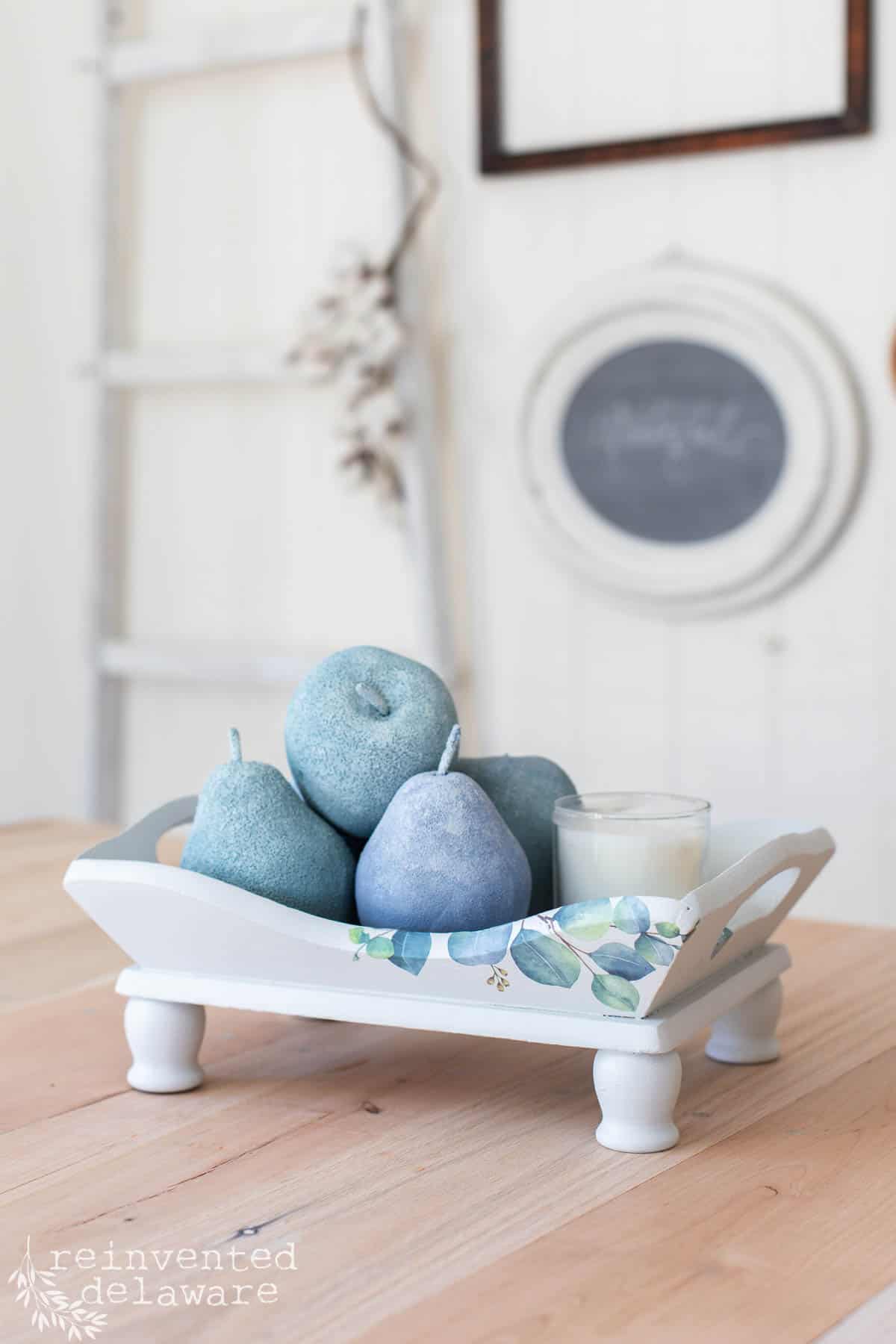 painted thrift store tray and faux fruit in the tray all painted in soft blue, green and gray colors.