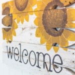 handmade porche welcome sign diy project with painted sunflowers and the word welcome painted on the bottom