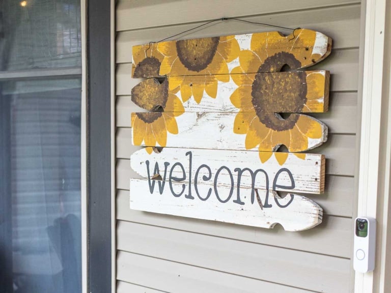 front porch welcome sign made with reclaimed fence boards and sunflower design