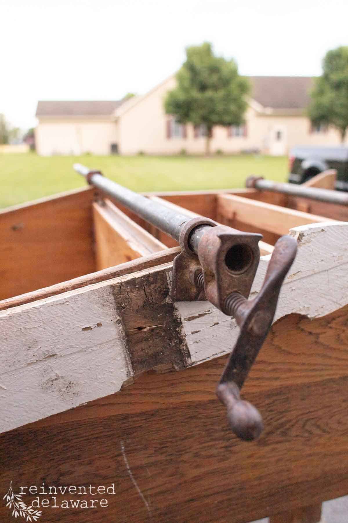 An old piece of furniture with wood glue and furniture clamps needed for a repair.