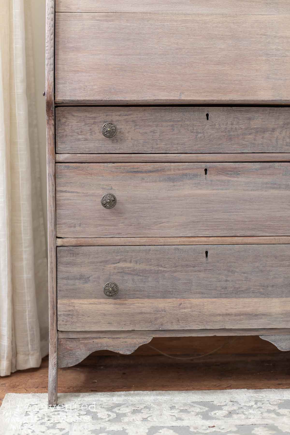 Detailed wood grain on a furniture makeover that used a whitewashing technique with milk paint.