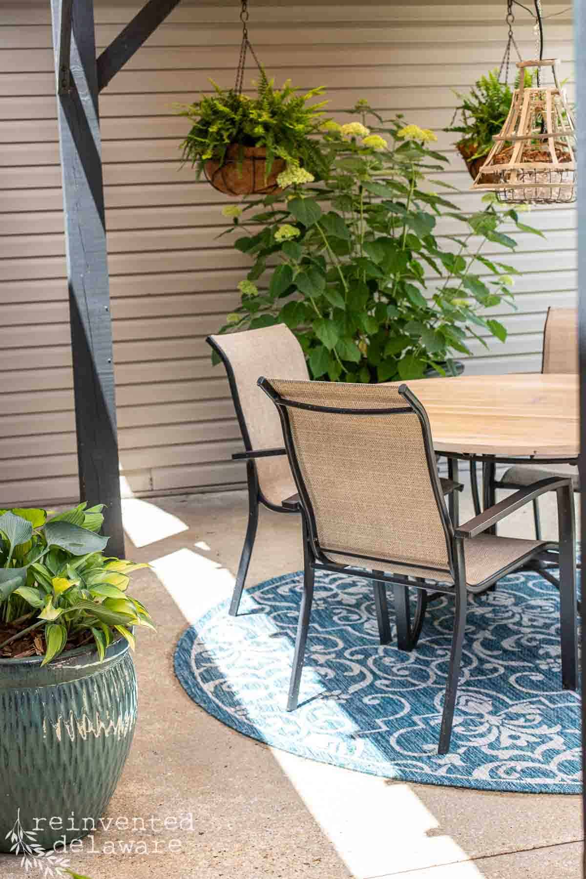 Area on a patio under a diy sun shade sail showing the shady area and the sunny area.