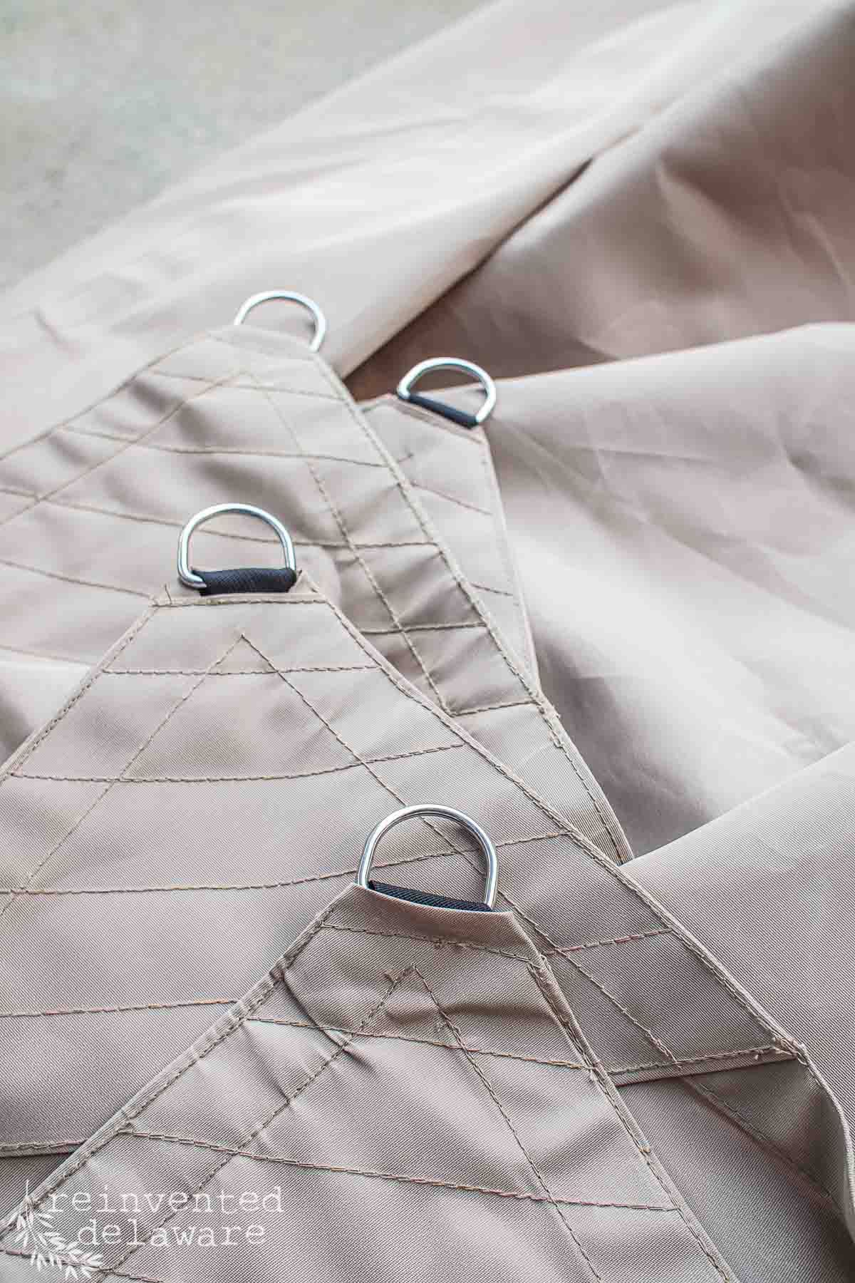 Close up of hardware metal rings on an outdoor sun shade.