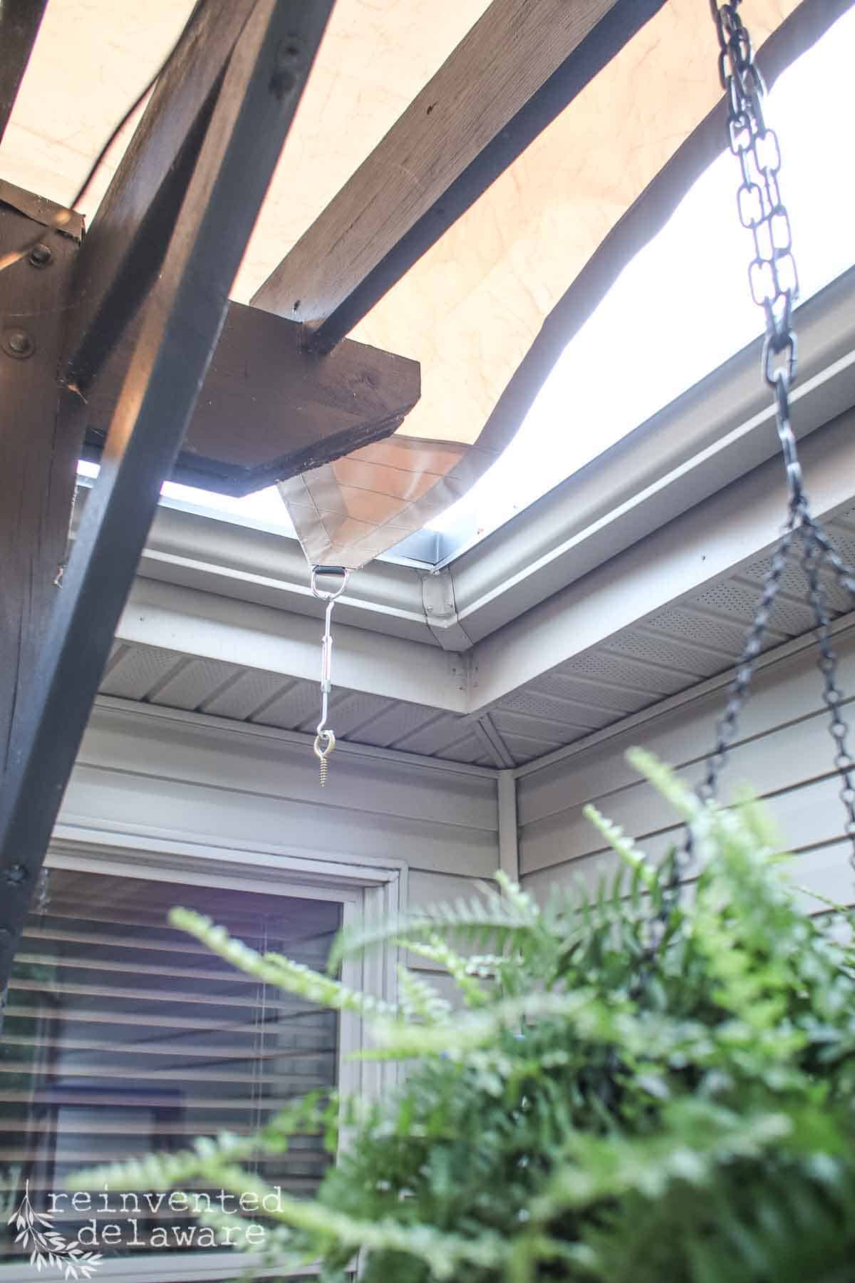 Hardware used to secure an outdoor sun shade to the exterior of a home.