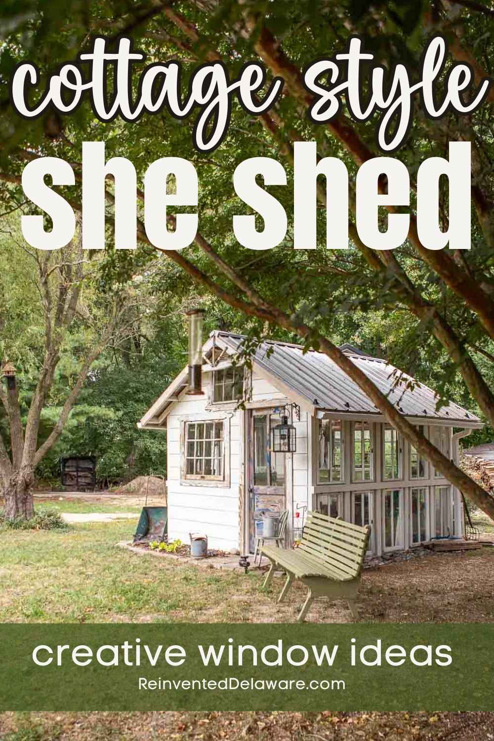 A charming white cottage-style she shed is set amidst a lush garden. A green swing hangs from a tree in front of the shed. "Cottage style she shed" and "creative window ideas" text is overlayed on the image, with "ReinventedDelaware.com" at the bottom.