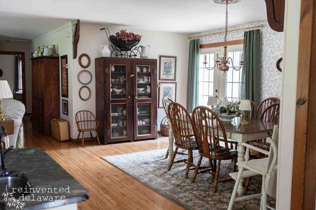 Charming dining room featuring a wooden table, vintage chairs, and classic decor.