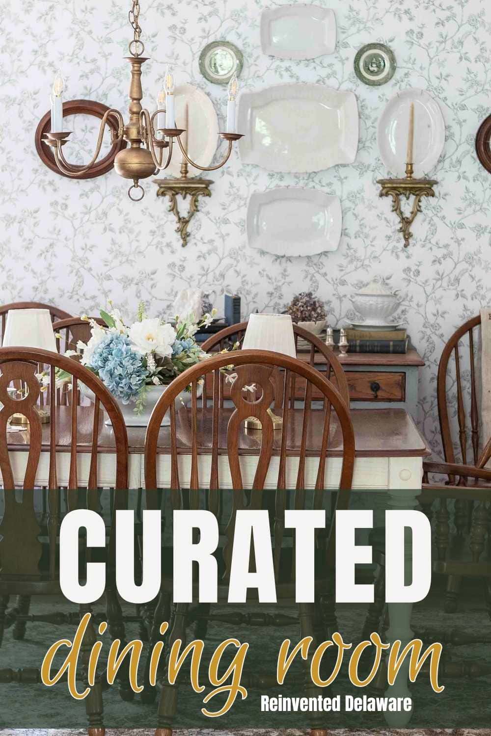 Charming vintage dining room with chandelier, floral wallpaper, and elegant table setting.